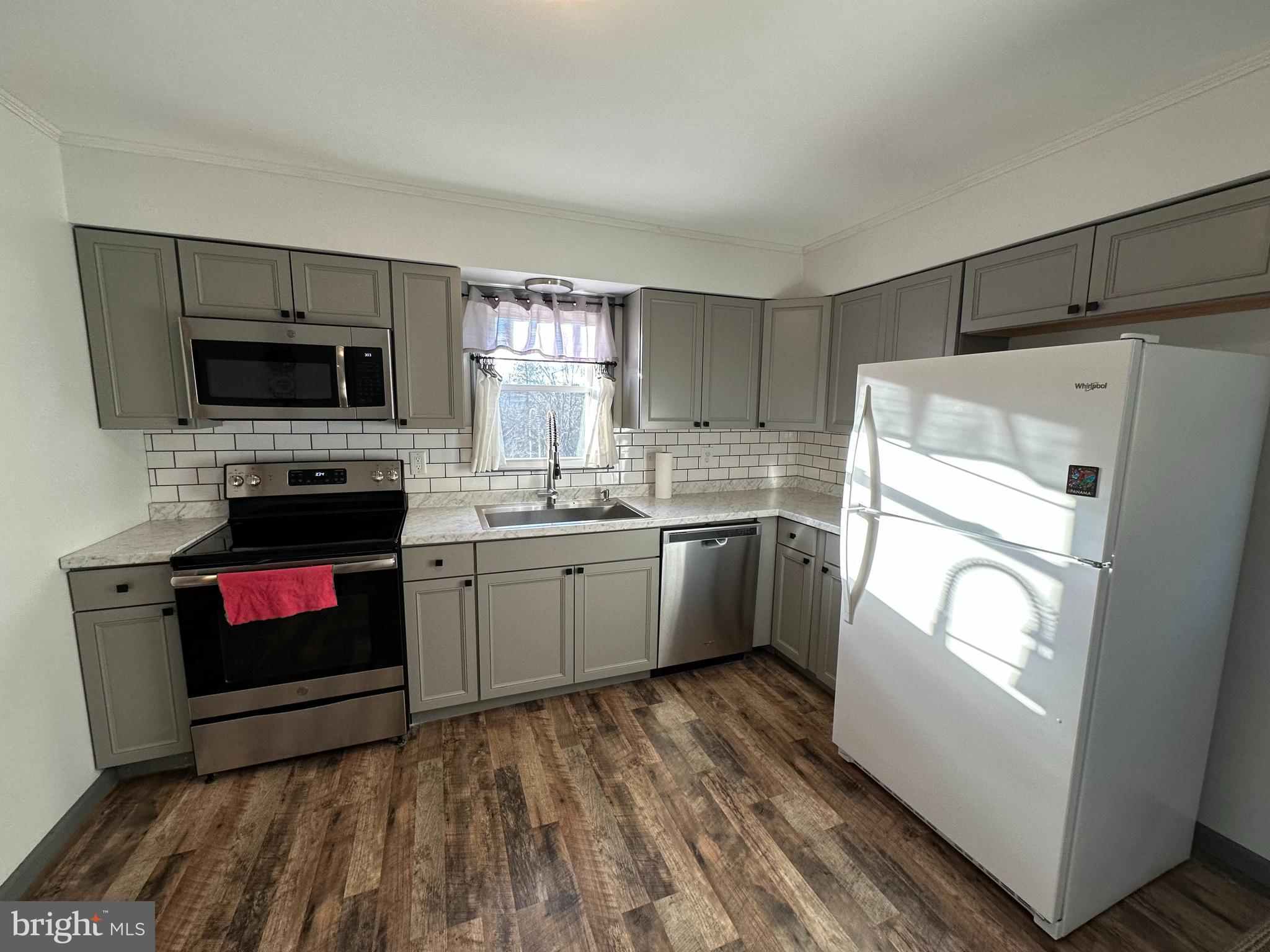 650 Honeyville Road Stanley, VA 22851 - Photo 17 of 27 a kitchen with a stove a sink and a microwave