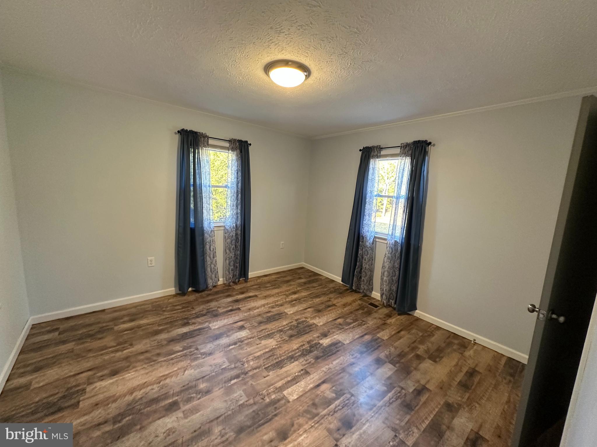 650 Honeyville Road Stanley, VA 22851 - Photo 18 of 27 a view of an empty room with wooden floor and a window