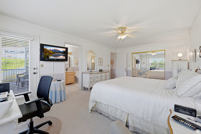 3766 Cardiff Circle Bountiful, UT 84010 - Photo 23 of 46 Bedroom featuring a ceiling fan, wall-mounted television, and a glass-paneled door opening to an outdoor area