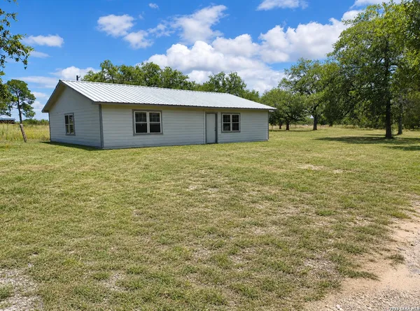 a house with huge green field in front of it