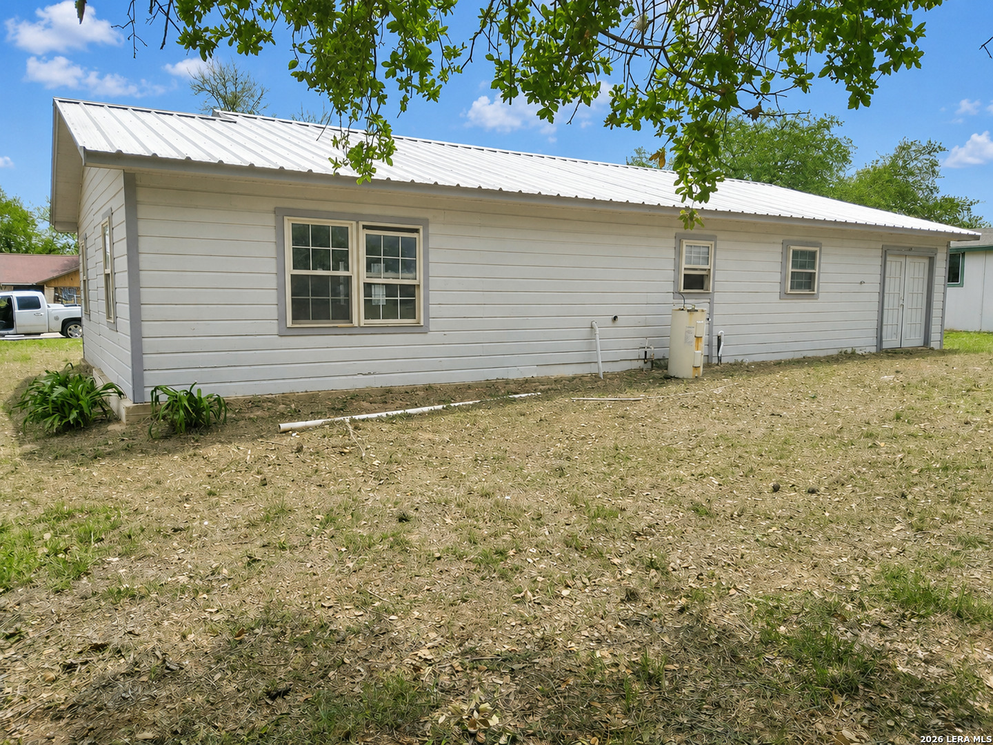 82 Lance Lane Poteet, TX 78065 - Photo 2 of 5 a house with trees in the background