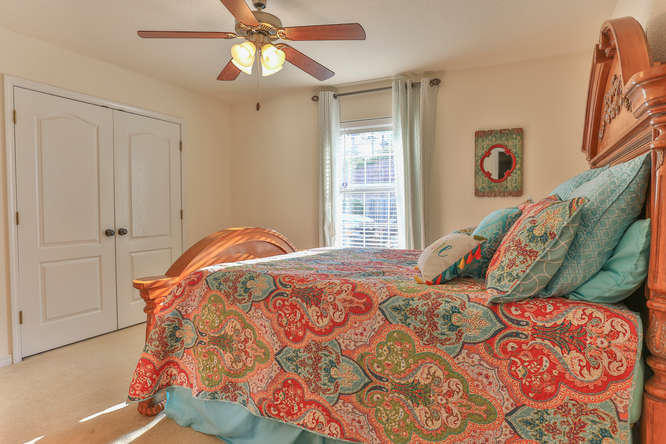 224 Shipwreck Road Santa Rosa Beach, FL 32459 - Photo 16 of 38 a bedroom with a bed and a chandelier