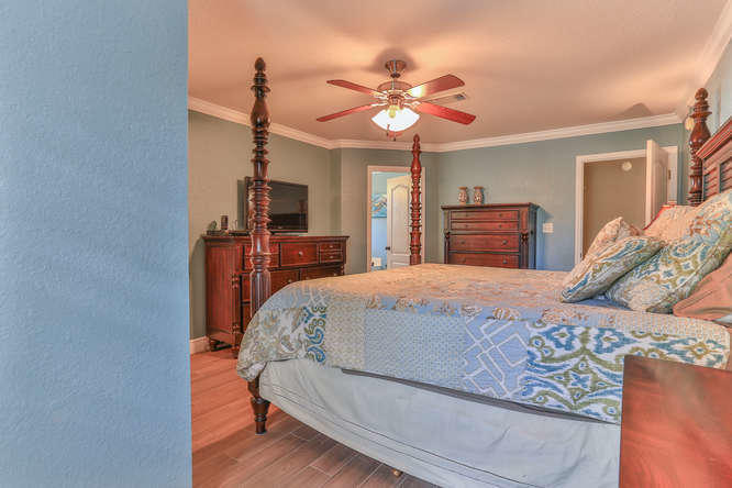 224 Shipwreck Road Santa Rosa Beach, FL 32459 - Photo 23 of 38 a bedroom with a bed and a chandelier