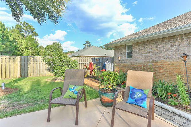 224 Shipwreck Road Santa Rosa Beach, FL 32459 - Photo 29 of 38 a view of a chair and table in backyard of the house