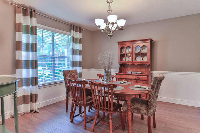 224 Shipwreck Road Santa Rosa Beach, FL 32459 - Photo 7 of 38 a view of a dining room with furniture wooden floor and chandelier