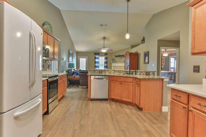 224 Shipwreck Road Santa Rosa Beach, FL 32459 - Photo 10 of 38 a large kitchen with a large counter top space a sink stainless steel appliances and cabinets