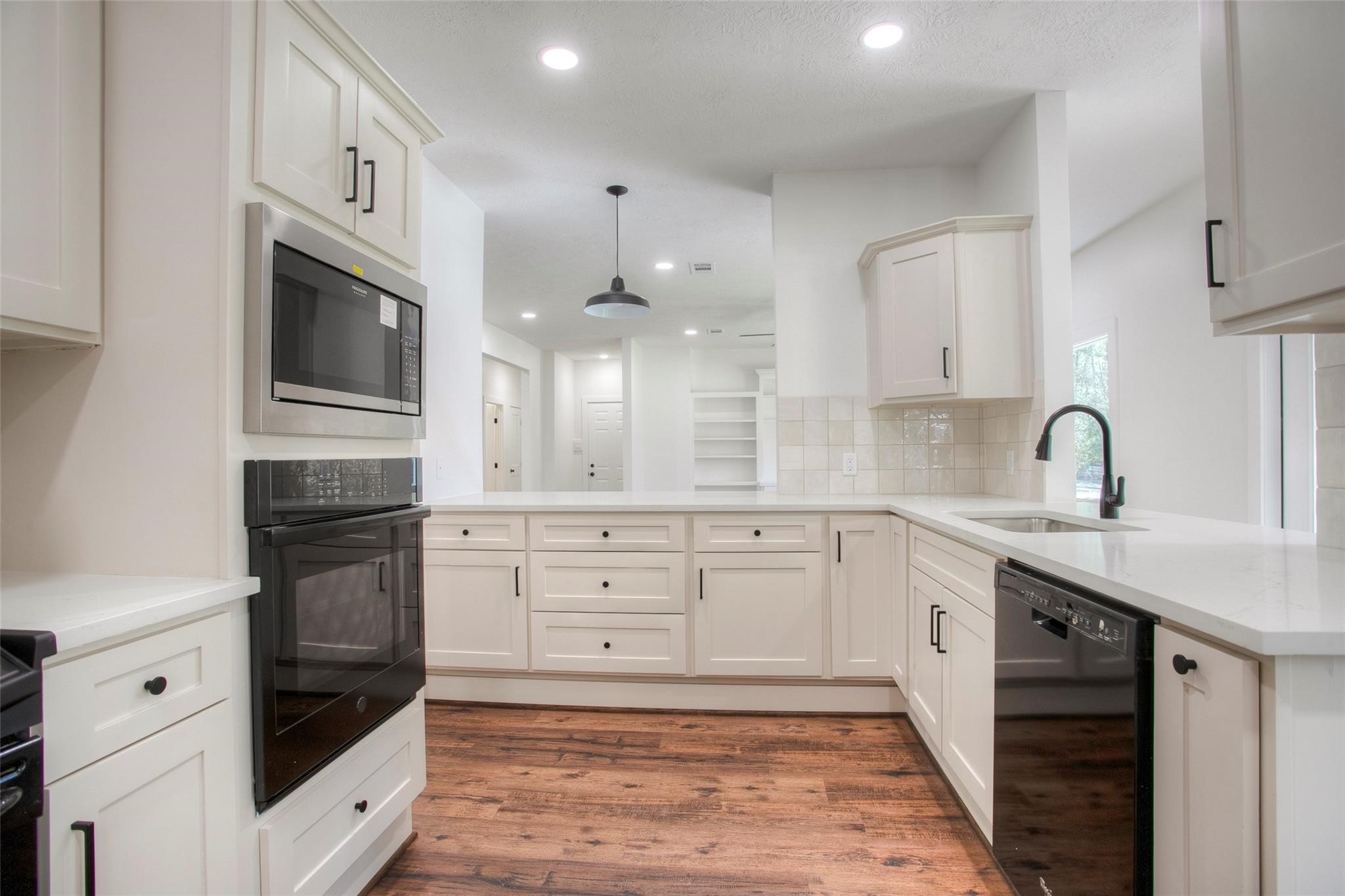 83 Dahlia Road Huntsville, TX 77320 - Photo 19 of 49 a kitchen with granite countertop white cabinets stainless steel appliances and a sink