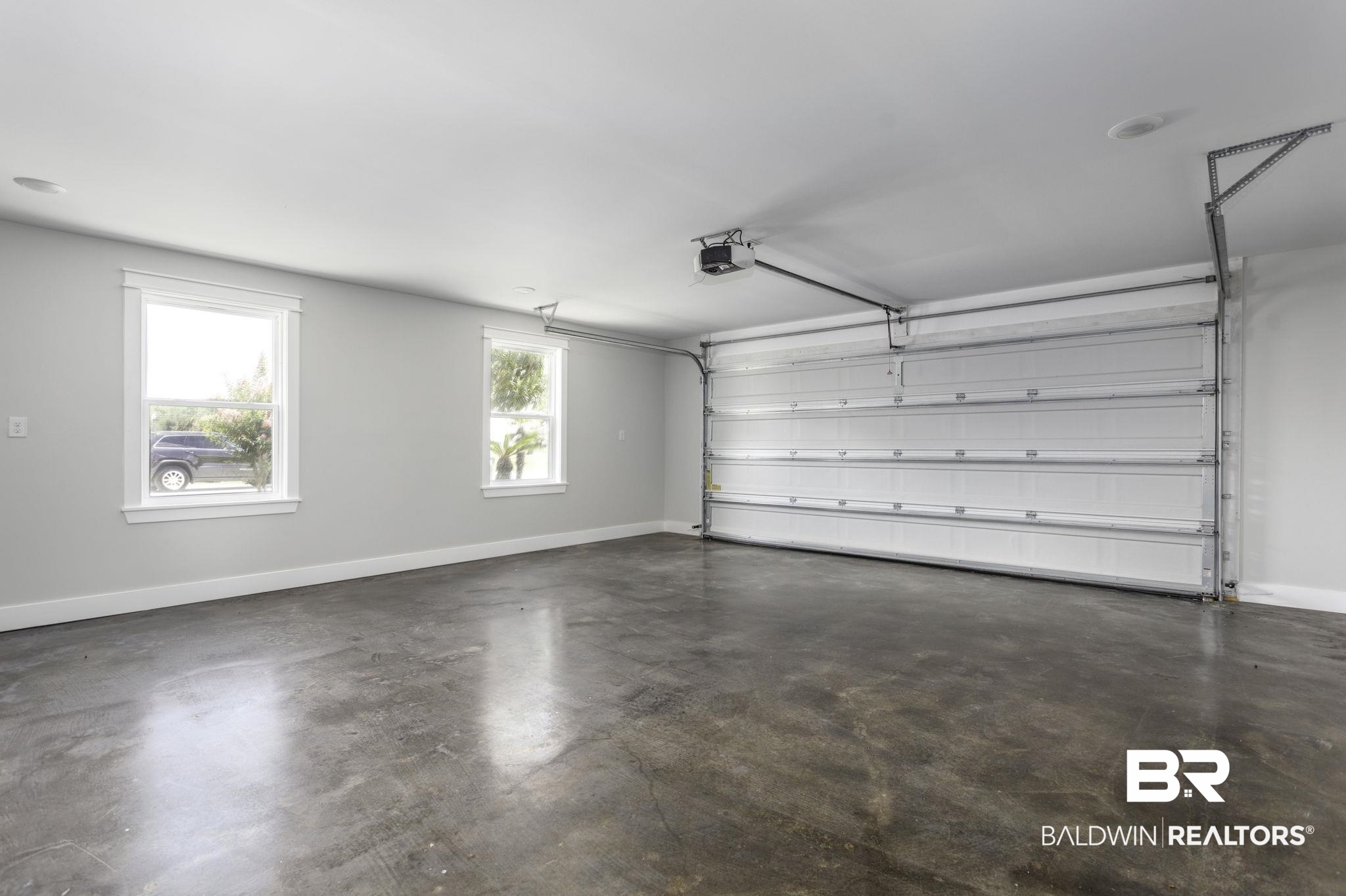 17126 Sugar Loop Foley, AL 36535 - Photo 21 of 28 Garage featuring a garage door opener and baseboards