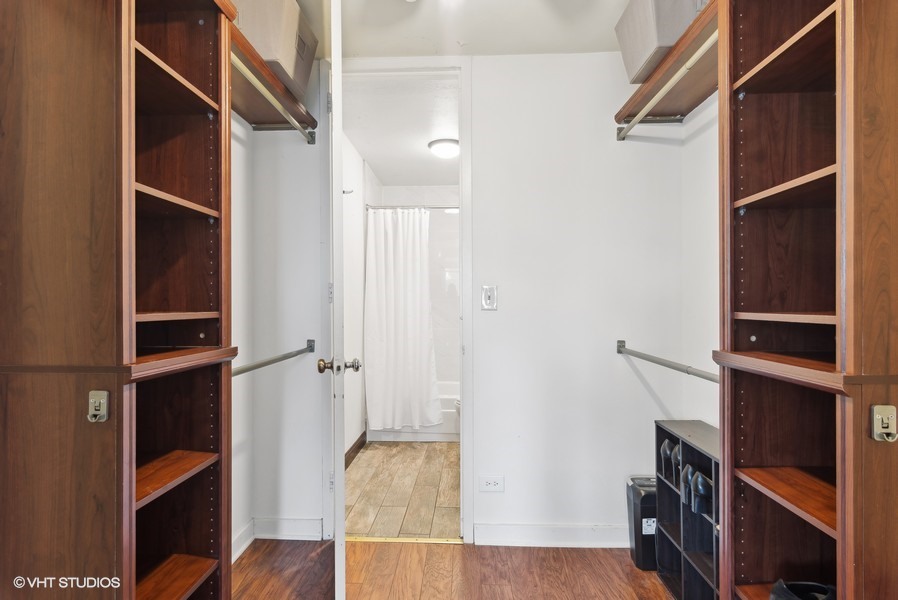1 East Scott Street, Unit 2011 Chicago, IL 60610 - Photo 11 of 13 a view of walk in closet with clothes and shoes