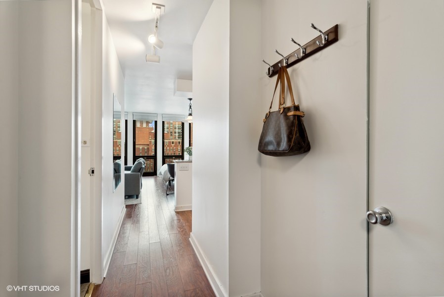1 East Scott Street, Unit 2011 Chicago, IL 60610 - Photo 2 of 13 a view of a hallway with wooden floor and closet