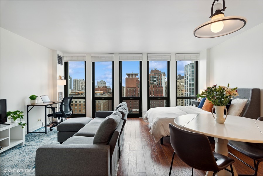 1 East Scott Street, Unit 2011 Chicago, IL 60610 - Photo 3 of 13 a living room with furniture and a floor to ceiling window