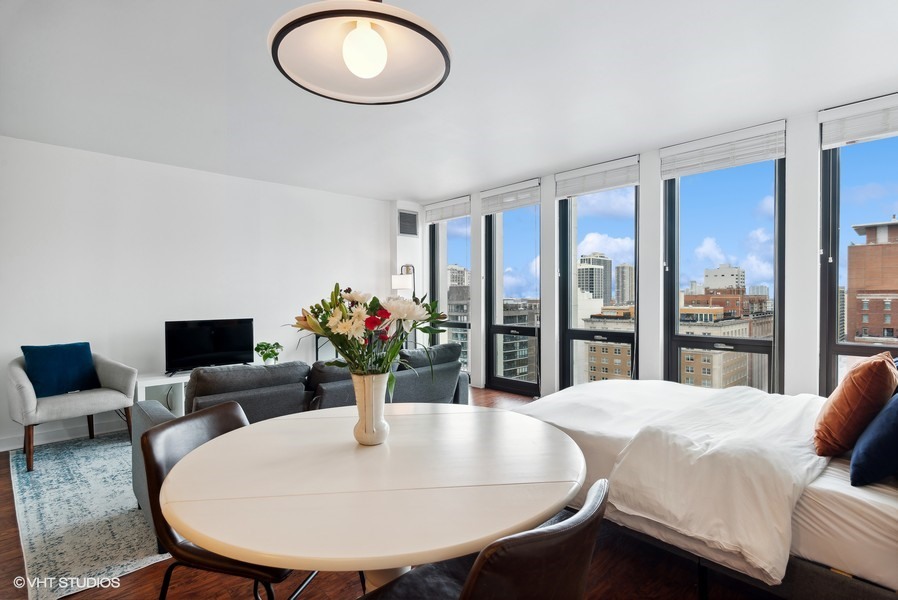 1 East Scott Street, Unit 2011 Chicago, IL 60610 - Photo 7 of 13 a dining room with furniture and a potted plant