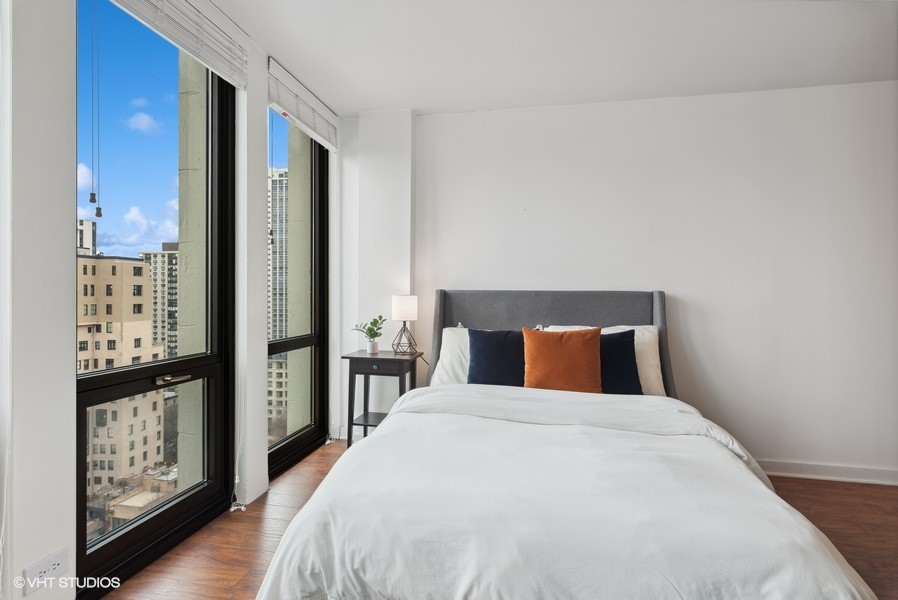 1 East Scott Street, Unit 2011 Chicago, IL 60610 - Photo 9 of 13 a bedroom with a large bed and a walk in closet