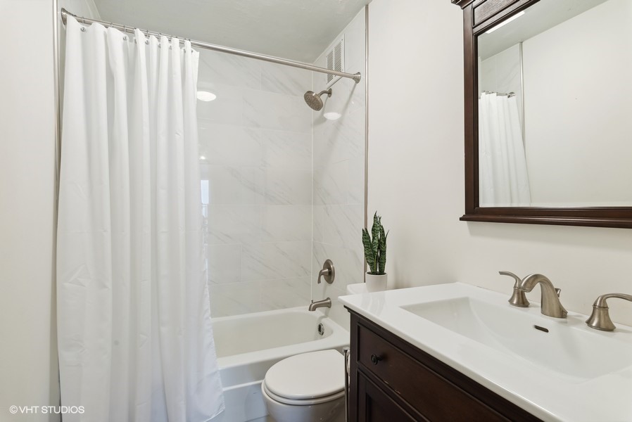 1 East Scott Street, Unit 2011 Chicago, IL 60610 - Photo 10 of 13 a bathroom with a sink a toilet and shower