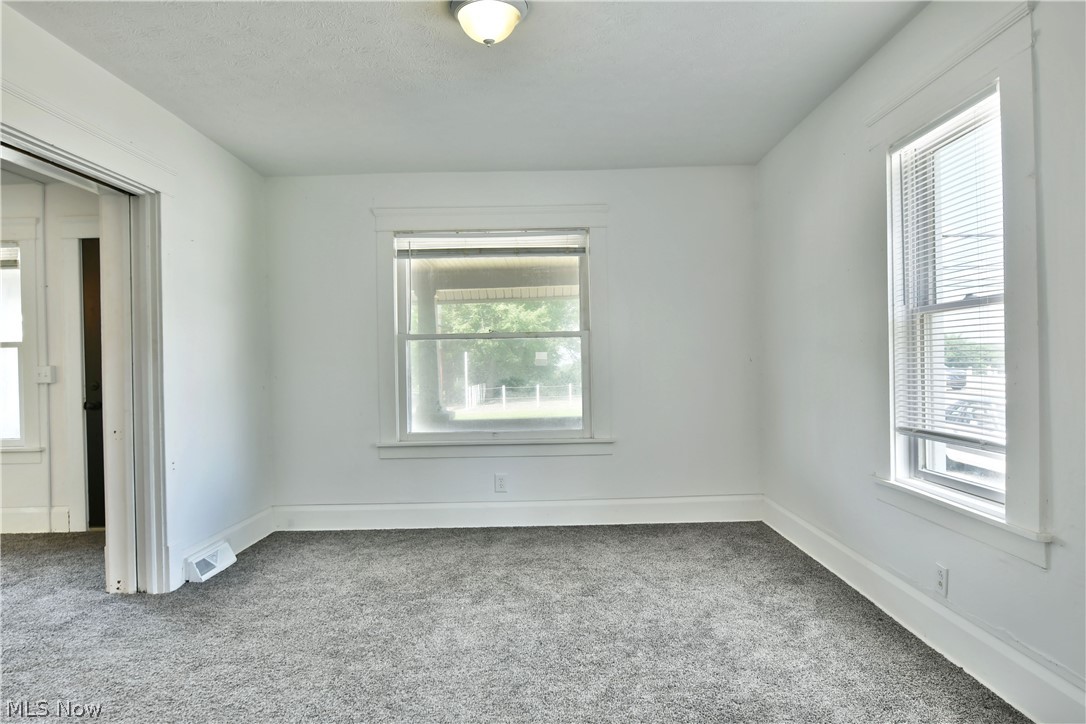 3617 South Main Street Mineral Ridge, OH 44440 - Photo 18 of 34 Spare room featuring carpet flooring and plenty of natural light