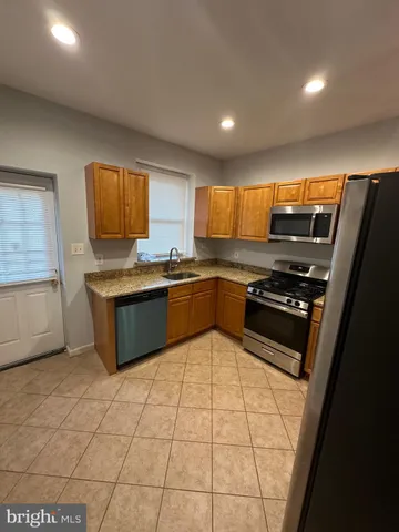 a kitchen with stainless steel appliances a stove a sink and a microwave