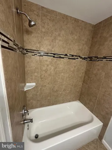 a bathroom with a tub and a shower