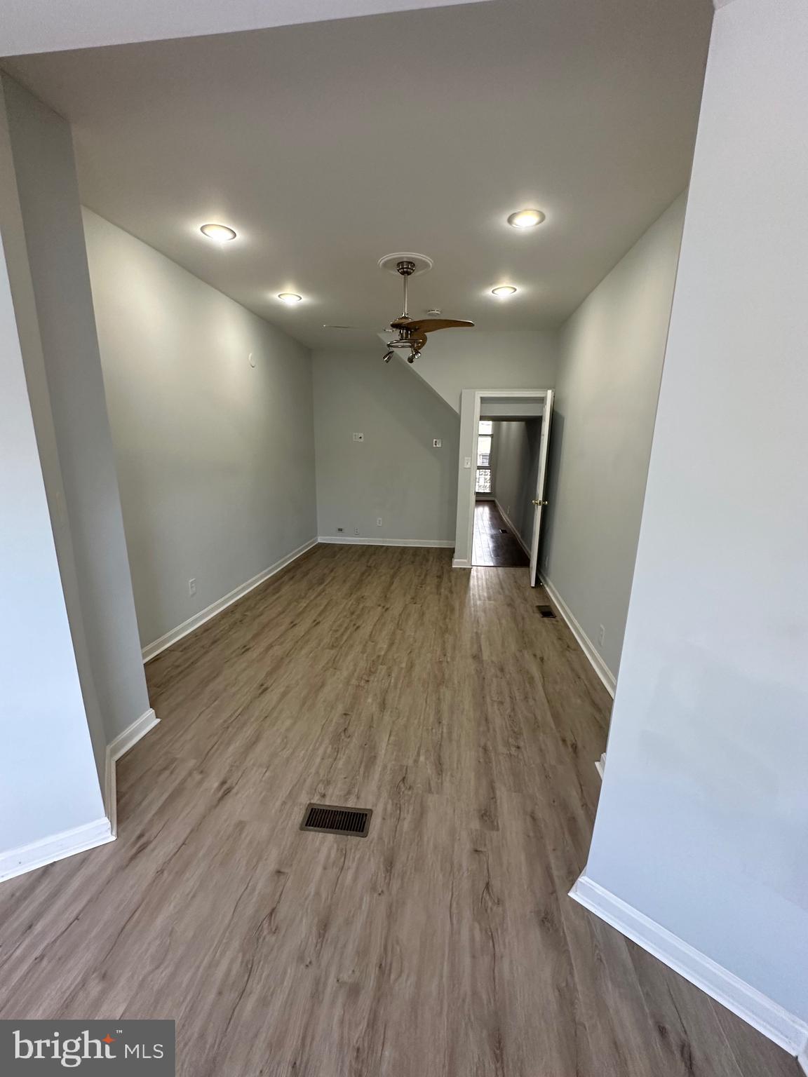 4331 Harford Road, Unit 1 Baltimore, MD 21214 - Photo 10 of 16 an empty room with wooden floor and windows