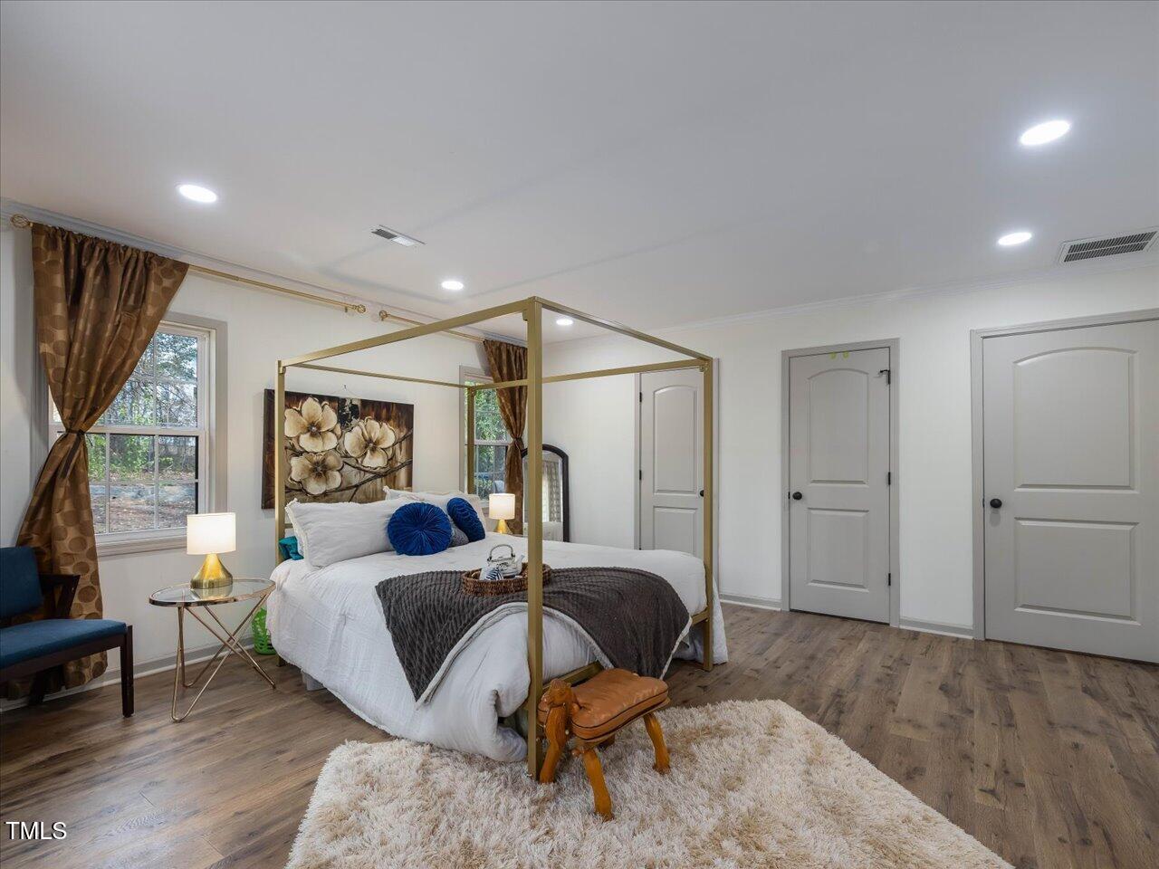 611 Dunbar Street Durham, NC 27701 - Photo 12 of 28 a bedroom with furniture and a wooden floor