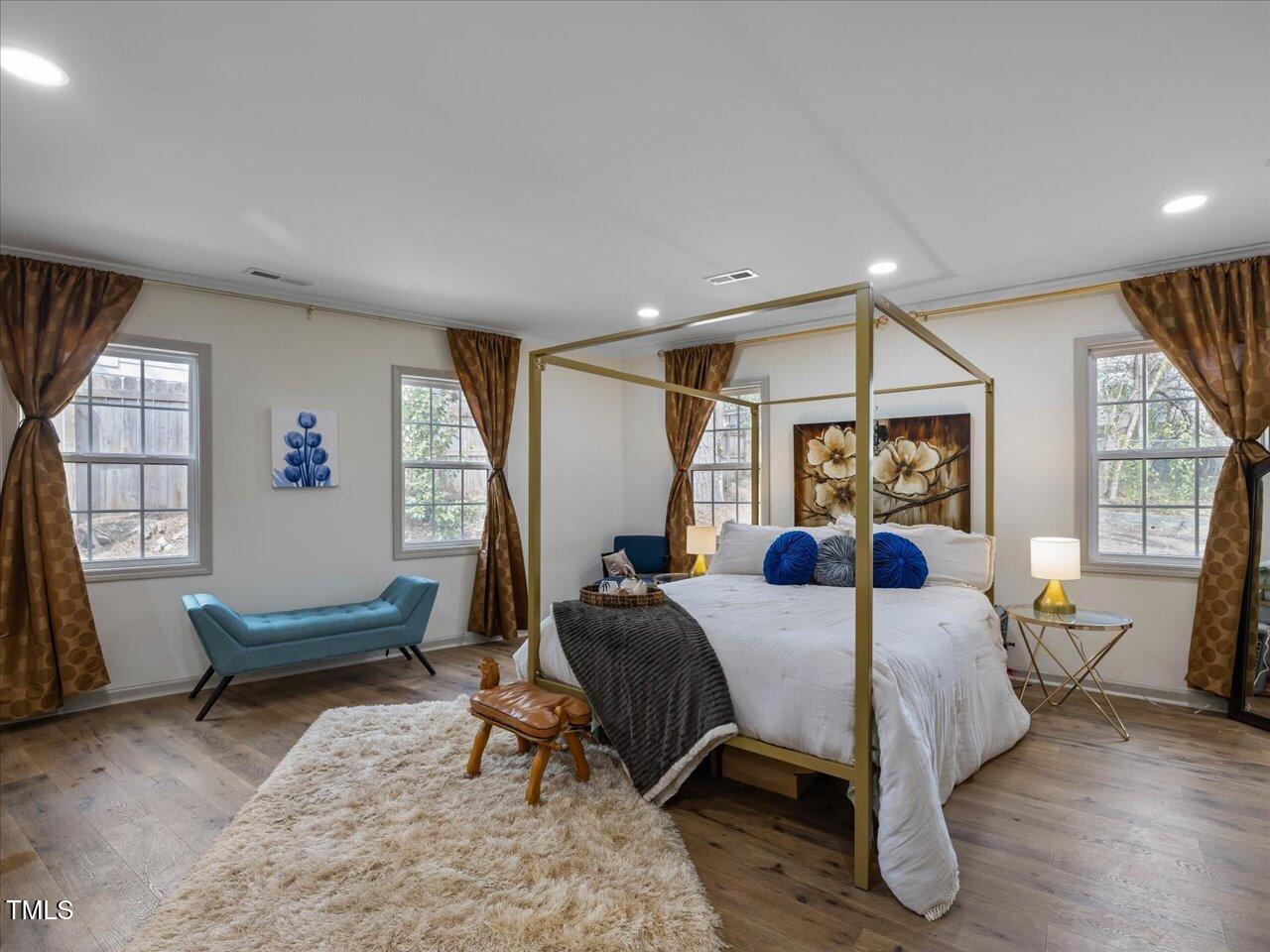 611 Dunbar Street Durham, NC 27701 - Photo 13 of 28 a bedroom with a bed a couch and a window