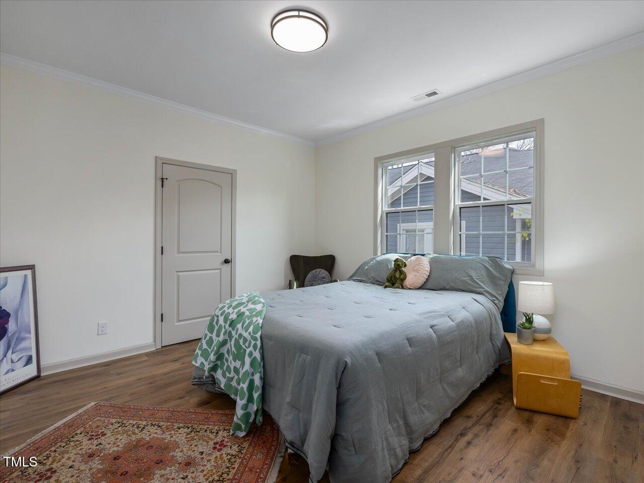 611 Dunbar Street Durham, NC 27701 - Photo 14 of 28 a bedroom with a bed and wooden floor