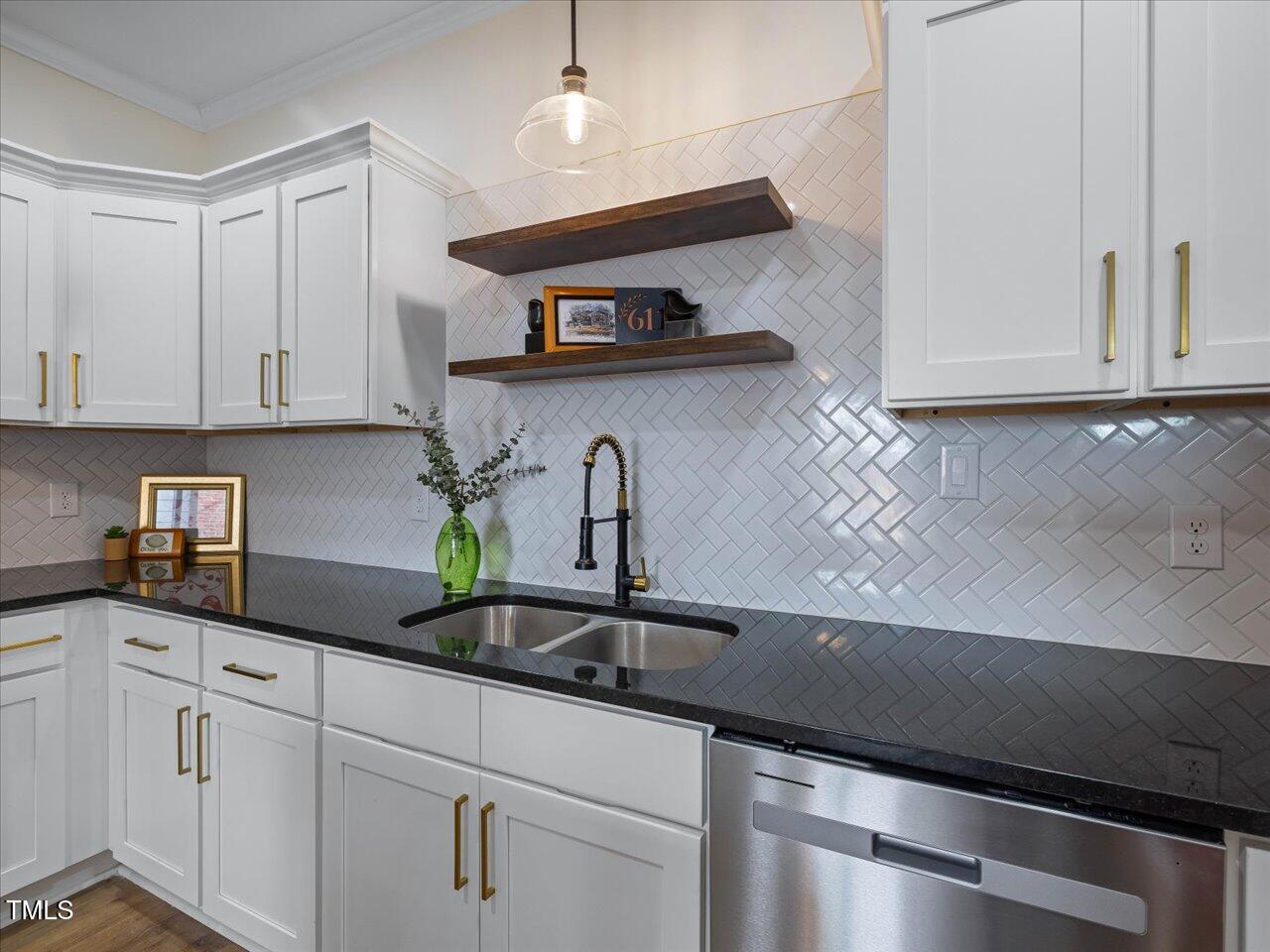 611 Dunbar Street Durham, NC 27701 - Photo 4 of 28 a kitchen with stainless steel appliances a sink a stove and cabinets