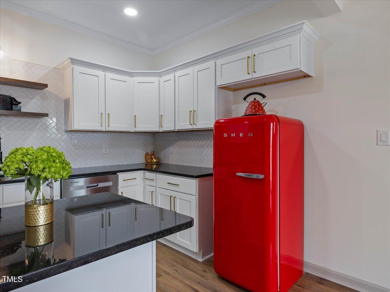 611 Dunbar Street Durham, NC 27701 - Photo 6 of 28 a kitchen with stainless steel appliances granite countertop a refrigerator a stove and a sink