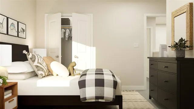 a bedroom with a bed and a painting on the wall