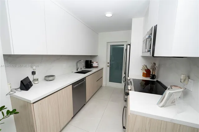 a kitchen with a sink a stove and microwave