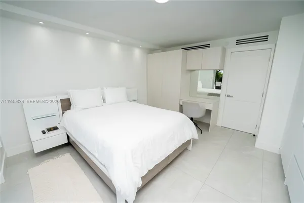 a bathroom with a sink a mirror a toilet and shower