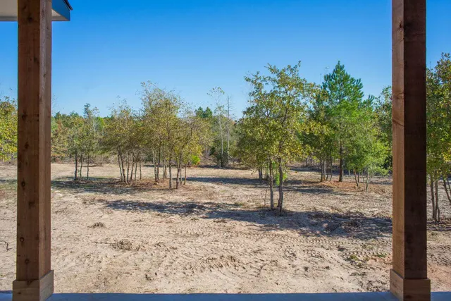 a view of a yard with wooden fence