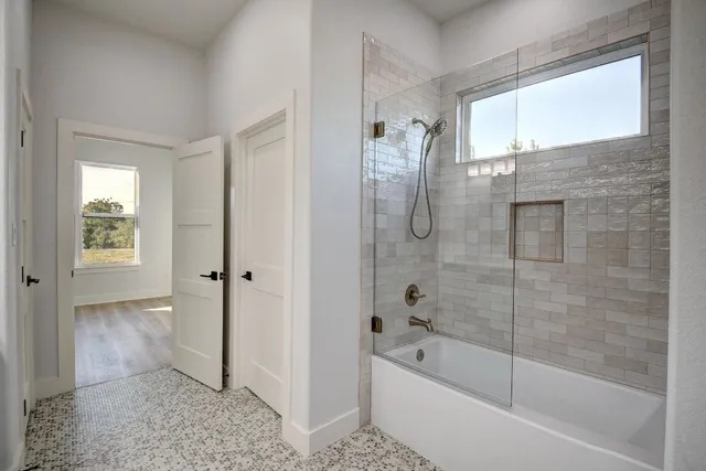 a bathroom with a bathtub and a shower