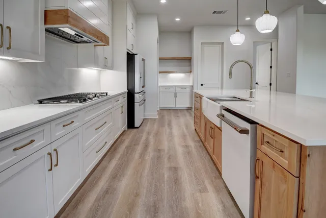 a kitchen with granite countertop a sink stove and cabinets