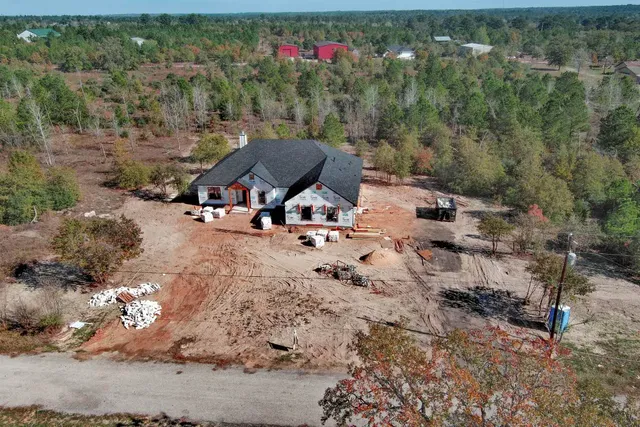 an aerial view of a house with a yard