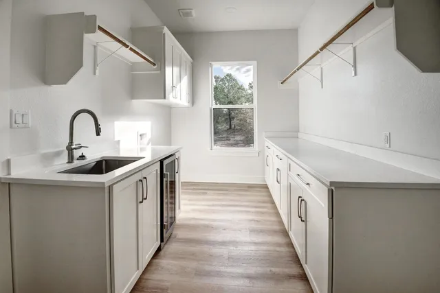 a kitchen with sink a stove and cabinets