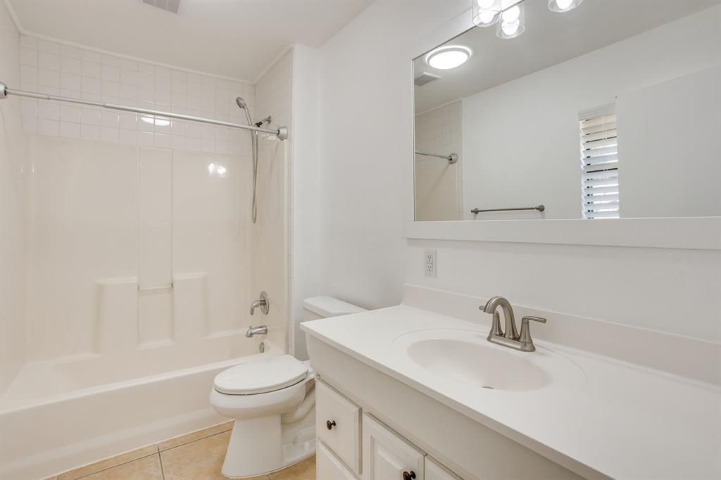 6940 Hatch Road Fort Worth, TX 76135 - Photo 29 of 40 Bathroom featuring a white vanity with integrated sink, brushed nickel faucet, and overhead lighting
