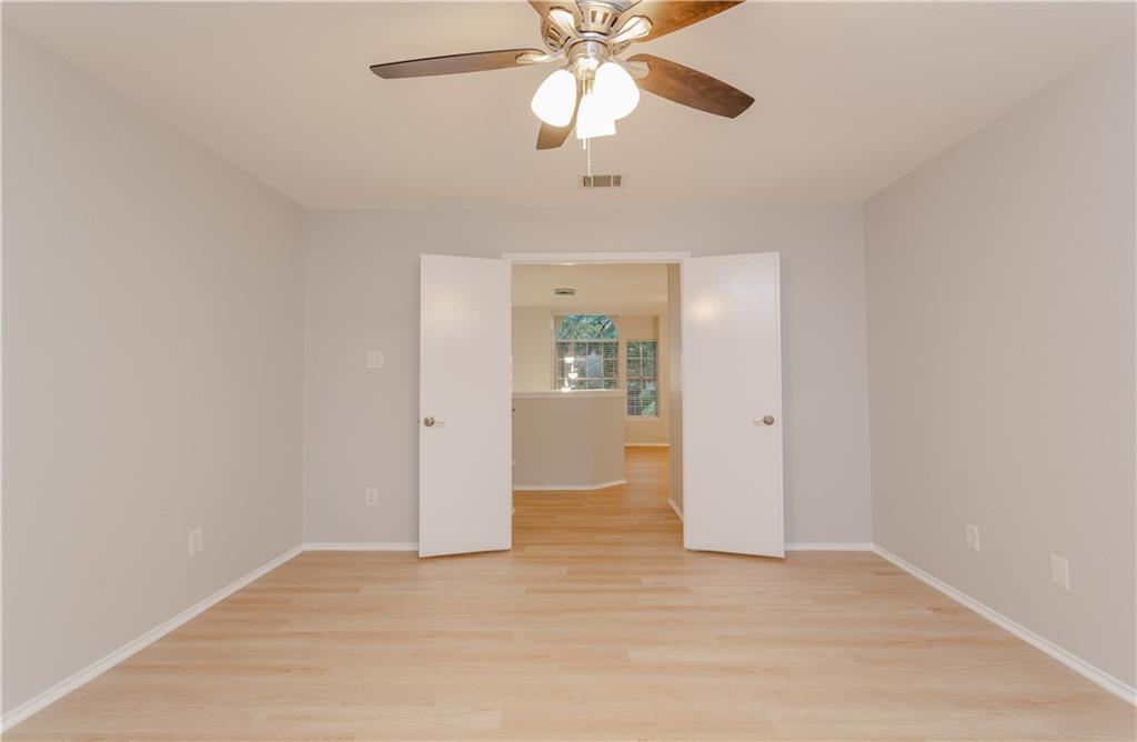 13207 Vendrell Drive Austin, TX 78729 - Photo 11 of 20 an empty room with fan and entrance