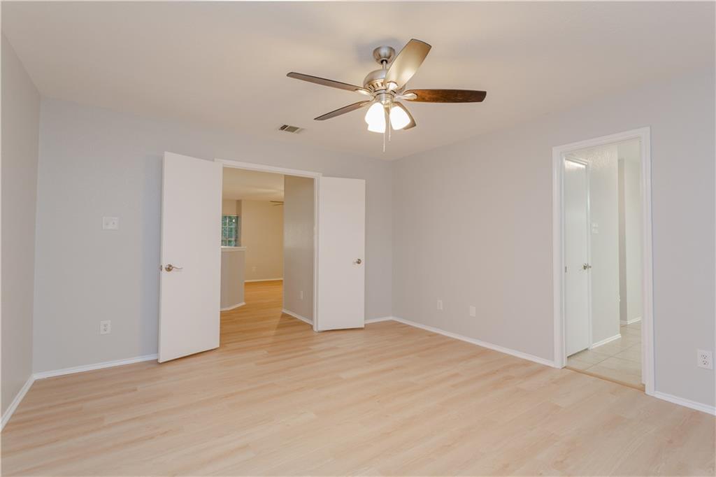 13207 Vendrell Drive Austin, TX 78729 - Photo 12 of 20 a view of an empty room with wooden floor