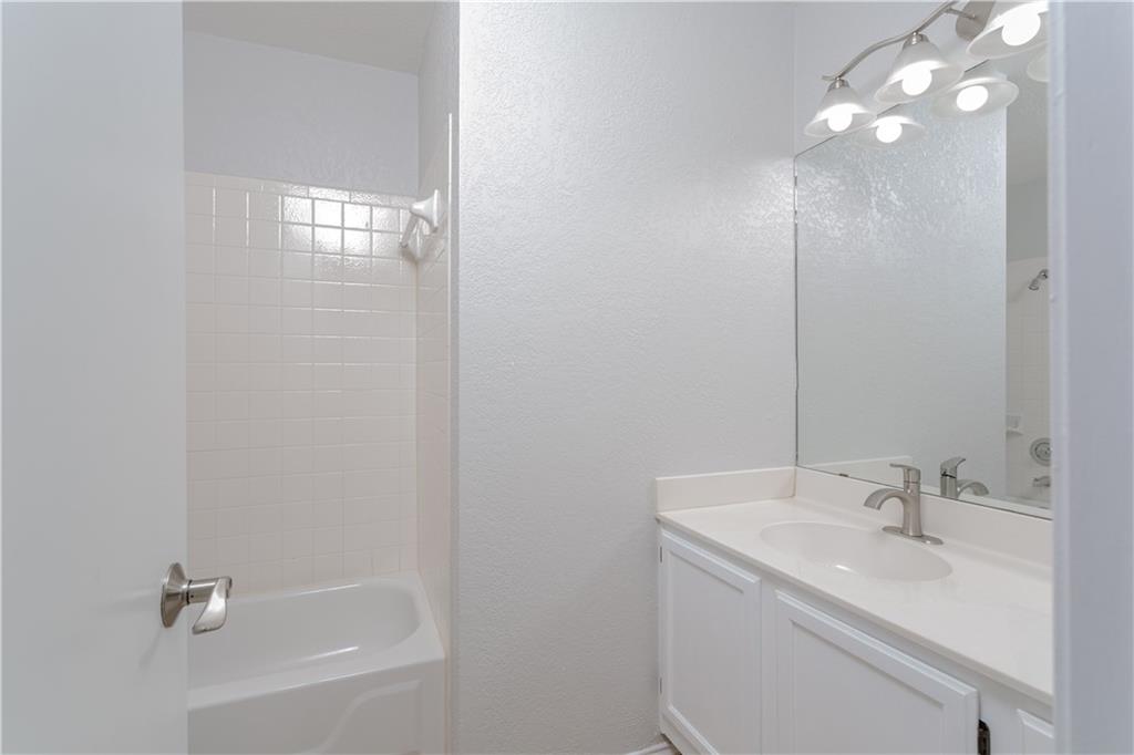 13207 Vendrell Drive Austin, TX 78729 - Photo 17 of 20 a bathroom with a sink shower and a mirror