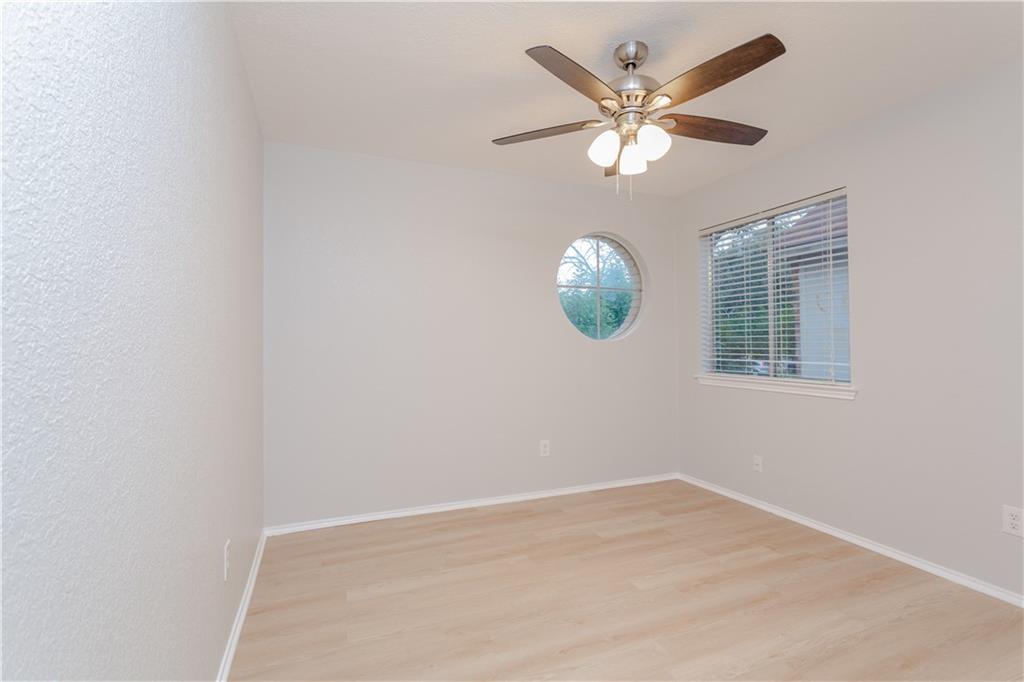 13207 Vendrell Drive Austin, TX 78729 - Photo 18 of 20 an empty room with windows and fan