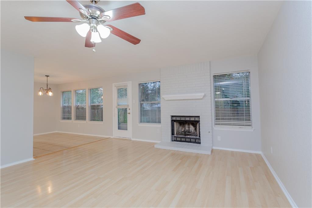13207 Vendrell Drive Austin, TX 78729 - Photo 2 of 20 a view of an empty room with a fireplace and a window