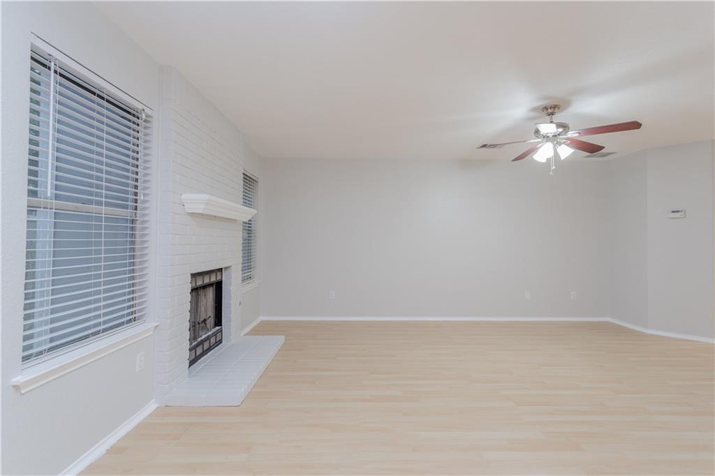13207 Vendrell Drive Austin, TX 78729 - Photo 5 of 20 a view of a livingroom with a fireplace a chandelier fan and wooden floor