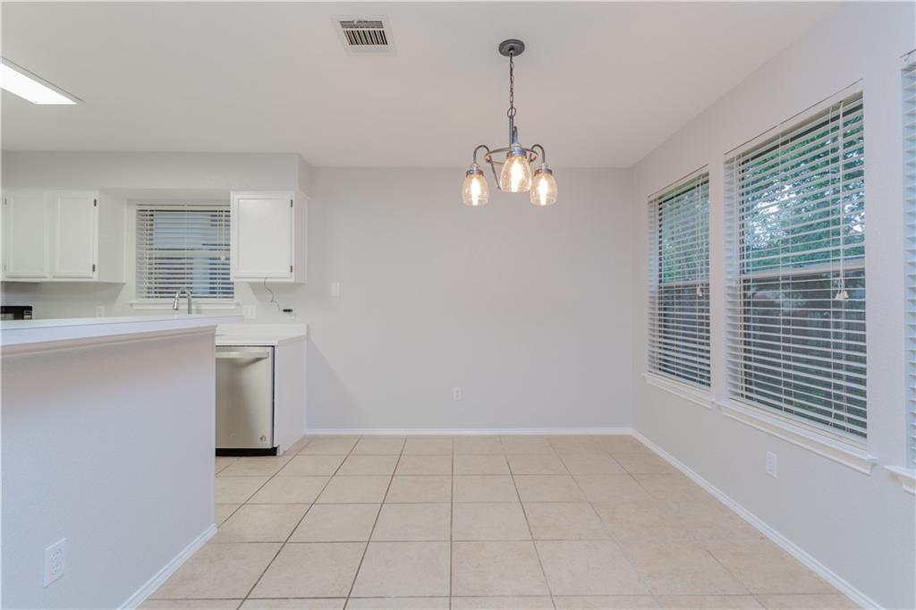 13207 Vendrell Drive Austin, TX 78729 - Photo 6 of 20 a view of a kitchen with a sink dishwasher and a wooden floor