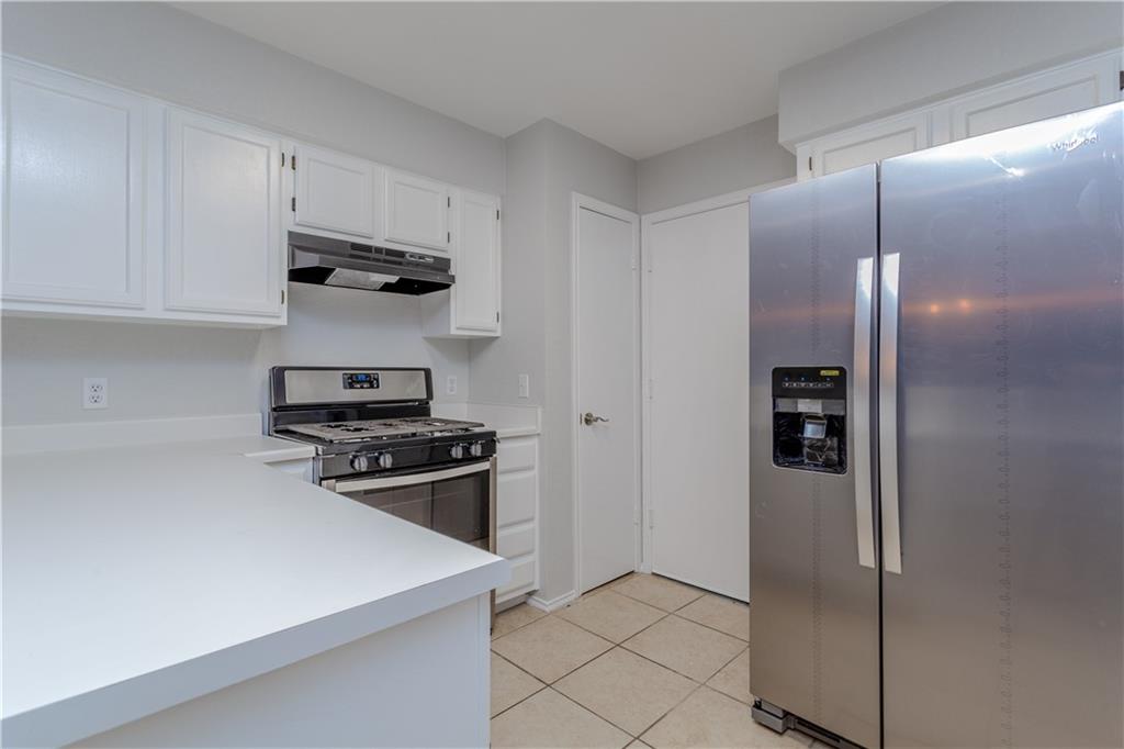 13207 Vendrell Drive Austin, TX 78729 - Photo 8 of 20 a kitchen with stainless steel appliances granite countertop a refrigerator and a stove