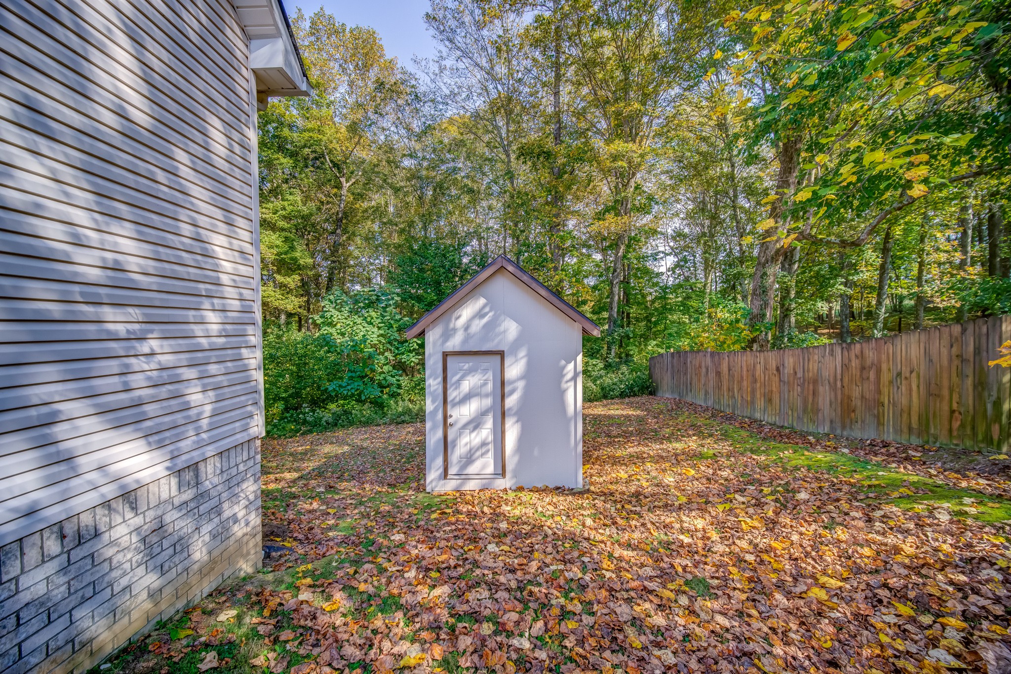 7583 Cherokee Hills Road Fairview, TN 37062 - Photo 7 of 50 a house view with a wooden fence next to a yard