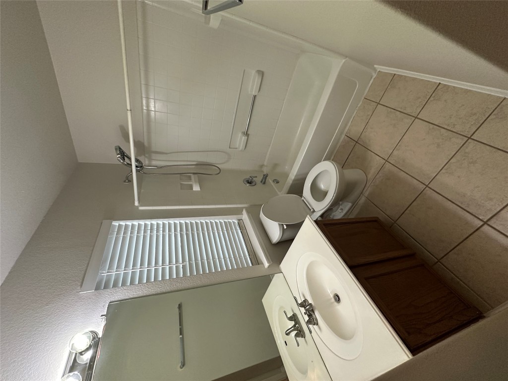 120 B Utterback Kyle, TX 78640 - Photo 15 of 24 a bathroom with a sink a toilet and shower