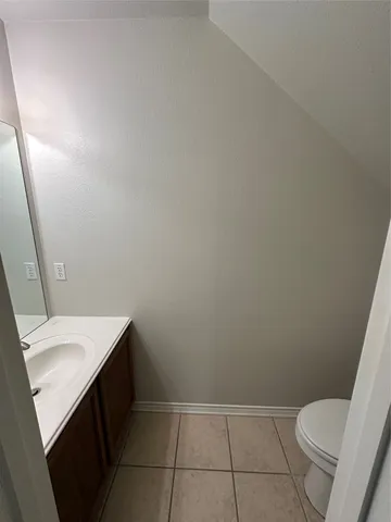 a bathroom with a sink toilet and vanity