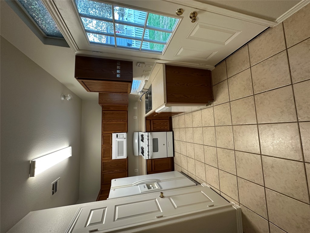 120 B Utterback Kyle, TX 78640 - Photo 20 of 24 a kitchen with stainless steel appliances a refrigerator sink and cabinets