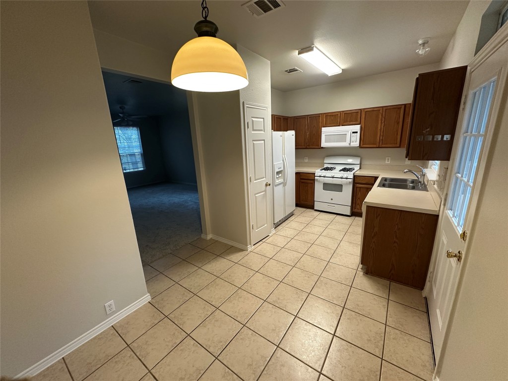 120 B Utterback Kyle, TX 78640 - Photo 21 of 24 a kitchen with stainless steel appliances a refrigerator and a stove top oven
