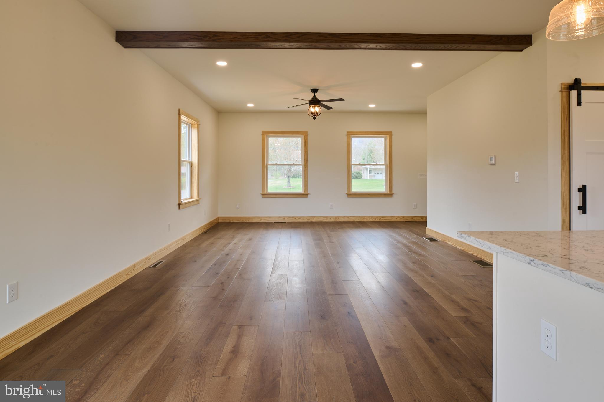 129 Lower Georges Valley Road Spring Mills, PA 16875 - Photo 26 of 61 an empty room with wooden floor and windows